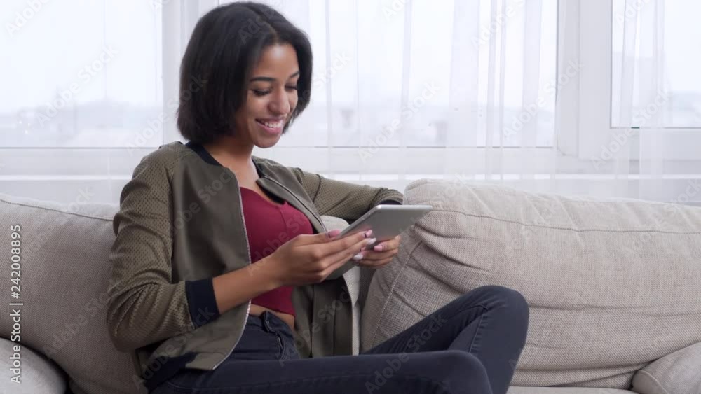 Teenage girl enjoying content on digital tablet Teenage girl enjoying content on digital tablet