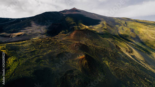 Aerial panorama of collapsed volcano cone  Mount Etna  Sicily  Italy.Etna  crater  scenic volcanic landscape popular tourist attraction hikers destination.People walking on edge of crater