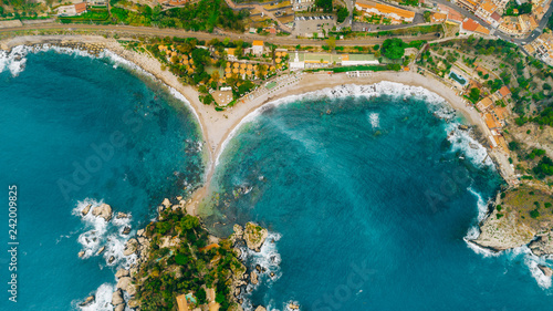 Aerial view of charming coastal Mediterranean small town on Sicily island  Taormina. Beaches of Taormina and south Italy.Travel destination  vacation in Italy concept.Aerial landscape of Bella Isola