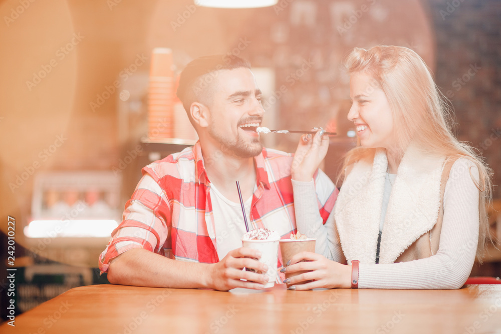 radioactivity Criticism salary Young beautiful loving couple guy and girl on date in cafe, she sexually  gives him lick tube of coffee. Stock Photo | Adobe Stock