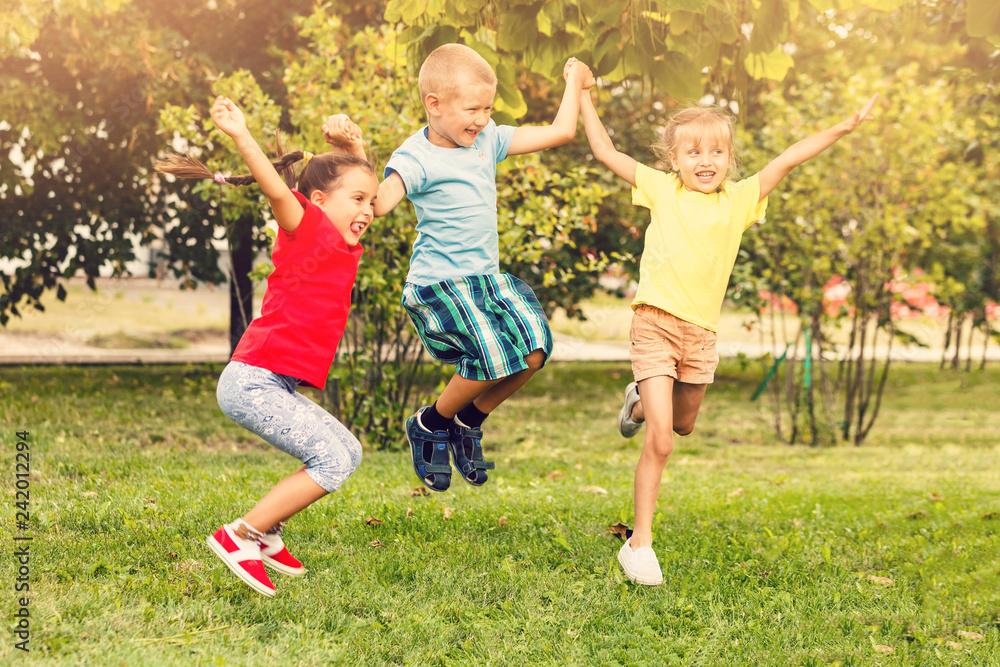 Large group of happy cheerful sportive children jumping and dancing ...
