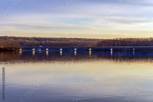 blue bridge over big lake against the evening sky