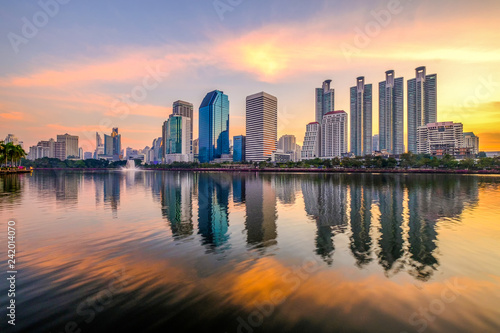 Business district cityscape from a park with sunrise time from Benchakitti park © panya7