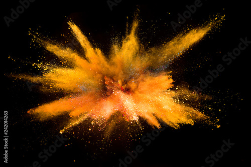 Explosion of colored powder on black background photo