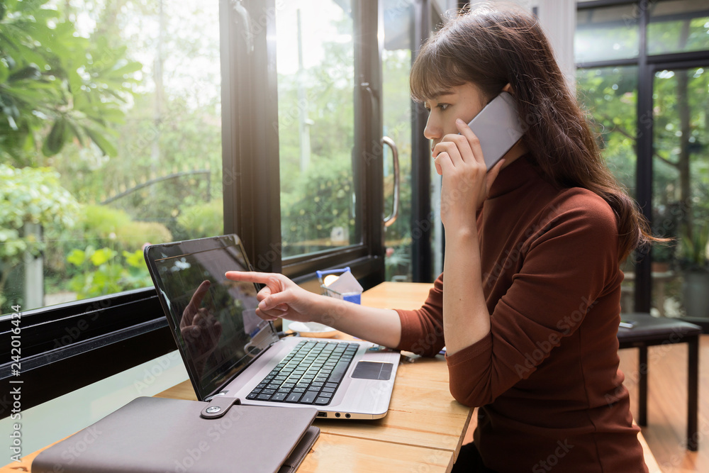 Beautiful young Asian woman using mobile phone for online shopping. Internet shopping lifestyle.