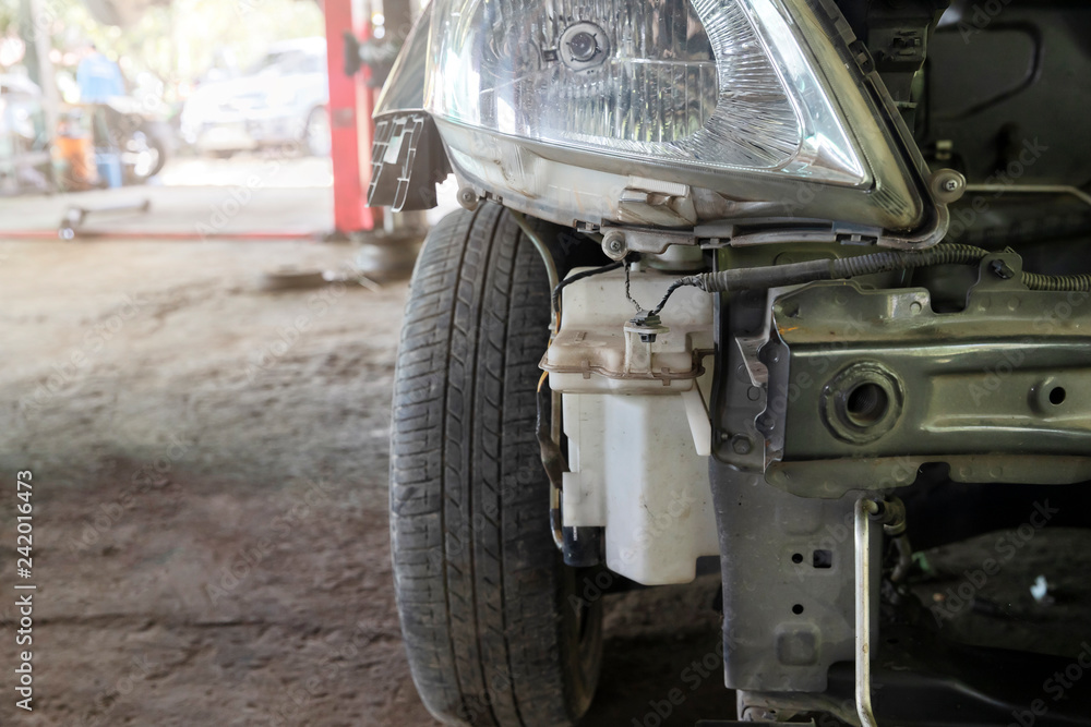 Close up of damaged car waiting to be repaired in the car repair garage. Close up of damaged car waiting to be repaired in the car repair garage.