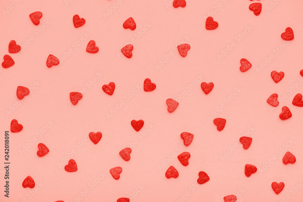 design concept of trendy color living coral sweet sprinkles of heart shapes like background, concept of St. Valentines Day