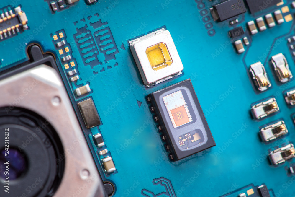 Heart rate sensor on a mobile phone main board next to led diode. Stock Photo Adobe Stock