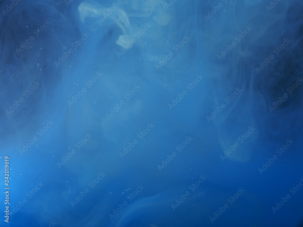 Blue paint is mixed with water. The dissolution of ink in water. Blue paint is mixed with water. The dissolution of ink in water.