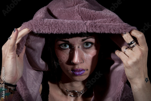 portrait of young tattooed woman with a purple sweatshirt