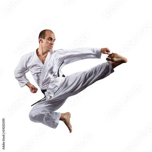 In jump, athlete beats kick on an isolated white background.