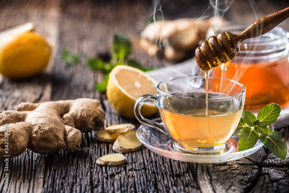 Ginger tea honey lemon and mint leaves on wooden table Ginger tea honey lemon and mint leaves on wooden table