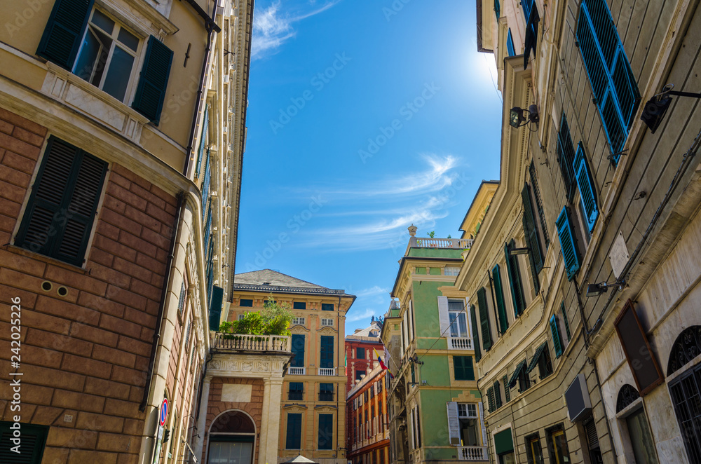 Piazza della Meridiana square with multicolored typical traditional buildings with colorful walls, windows with shutters in historical centre of old european city Genoa (Genova), Liguria, Italy
