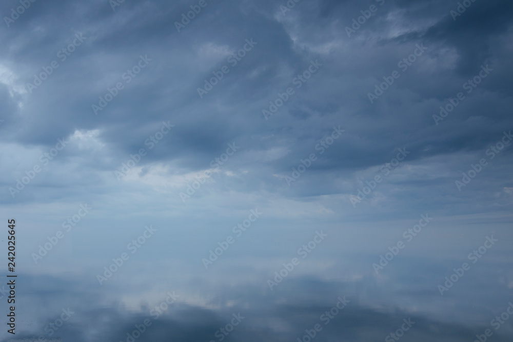 Clouds covered the sky over the ocean. The surface of the ocean