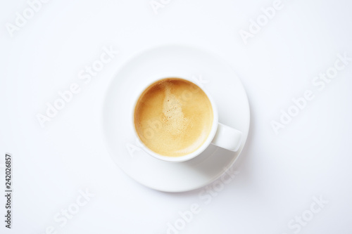 Cup of coffee on white background. Top view. Copy space.