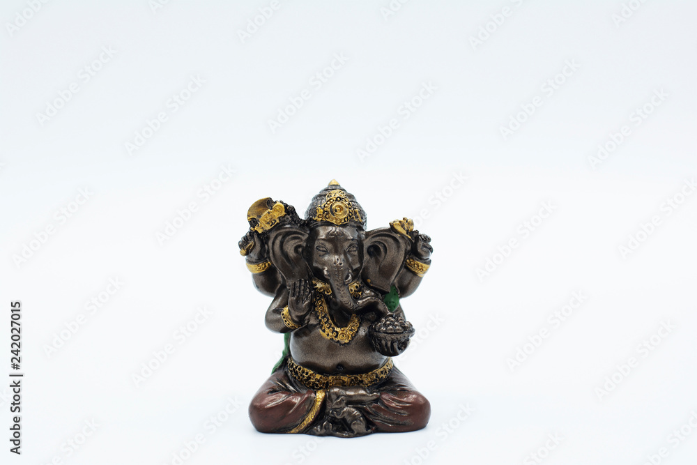 An ornate statue of ganesh / ganesha statue on an isolated white background An ornate statue of ganesh / ganesha statue on an isolated white background