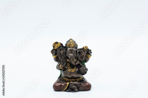 An ornate statue of ganesh / ganesha statue on an isolated white background