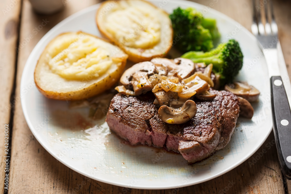 Steak with mushroom sauce, baked potatoes, broccoli Steak with mushroom sauce, baked potatoes, broccoli