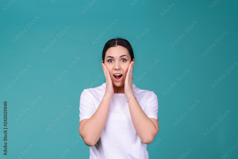 Shocked and surprised girl screaming and looking into camera. Woman in white t shirt wih wide open eyes amazed by sale prices. Expressive facial expressions. incredible result Shocked and surprised girl screaming and looking into camera. Woman in white t shirt wih wide open eyes amazed by sale prices. Expressive facial expressions. incredible result
