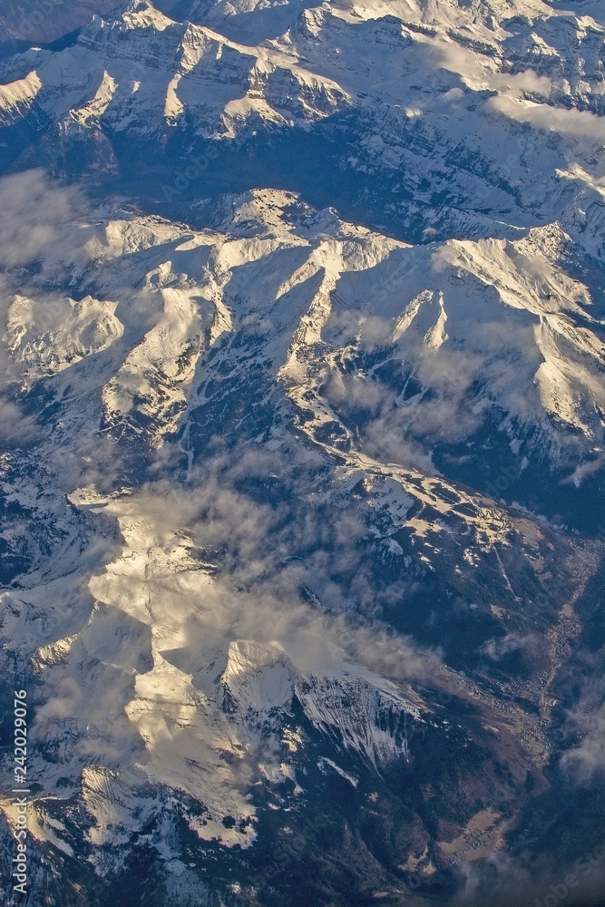 Fototapeta premium Swiss Alpes with snowy mountain tops aerial