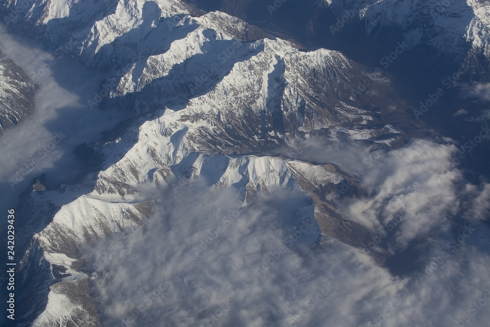 Fototapeta premium Swiss Alpes with snowy mountain tops aerial