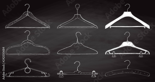 Set of clothes hangers on a chalkboard. Vector.
