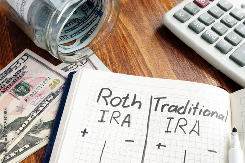 Roth IRA vs Traditional IRA written in the notepad. photo