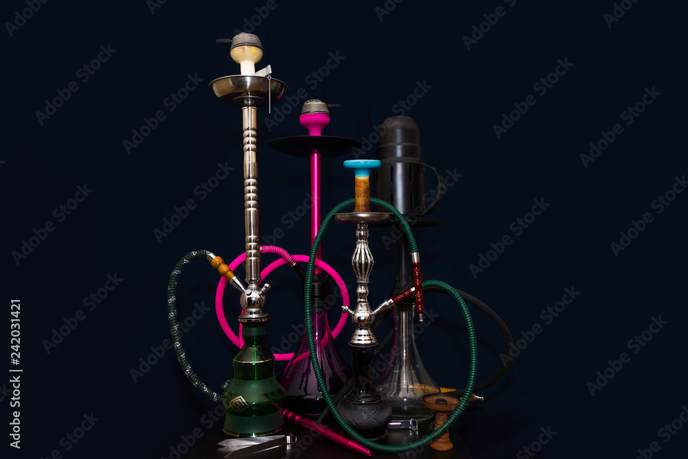 four different hookahs on the table on a dark blue background four different hookahs on the table on a dark blue background