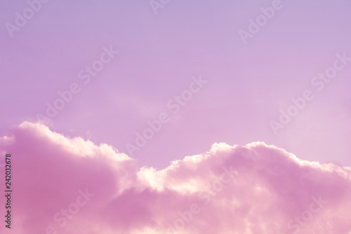 Gently pink sky with fluffy clouds (copy space, background, toned)