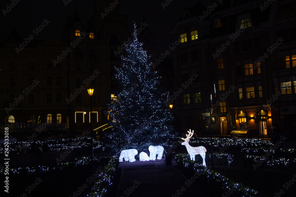 Christmas tree and festive illuminations in the city street