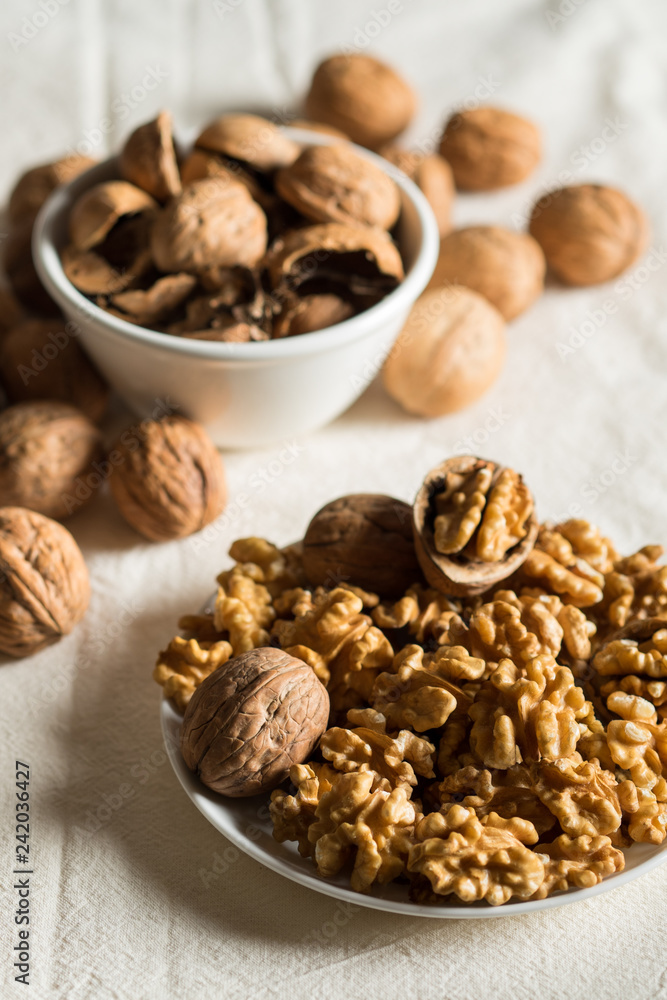 Peeled walnuts and shells on a light background Peeled walnuts and shells on a light background