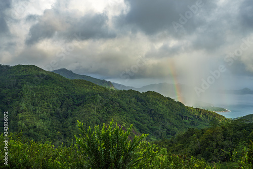 rainbow and rain over the jungle and mountains of mahé, seychelles 12