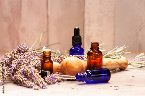 lavender mortar and pestle and bottles of essential oils for aromatherapy