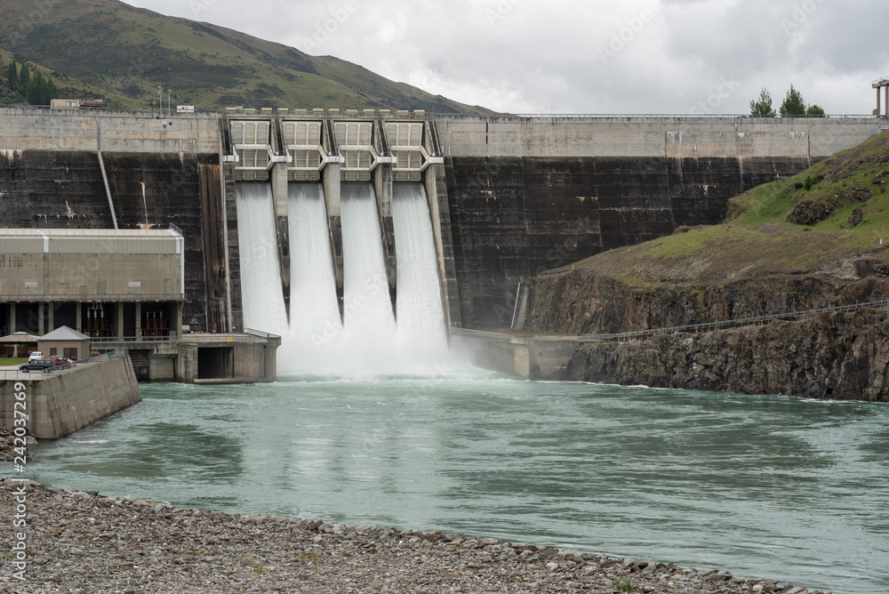 The Clyde hydroelectric power dam spilling large amounts of excess water. Clyde, Otago, New Zealand. The Clyde hydroelectric power dam spilling large amounts of excess water. Clyde, Otago, New Zealand.