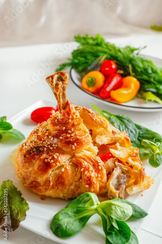 Chicken legs in dough with vegetables and lettuce.