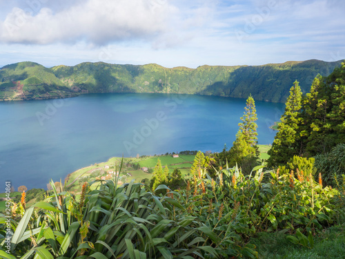 view of landscape with green and blue crater lakes of Lagoa Azul and Lagoa Verde and Sete Cidades village in the crater of dormant volcanoes, on Sao Miguel island, Azores, Portugal. photo