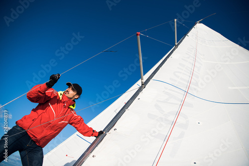 Photos Young man working on sailing ship, active lifestyle, summer sport concept