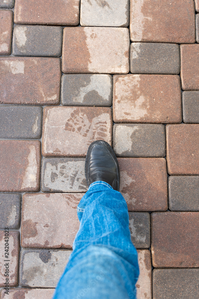 man's foot walking down the sidewalk man's foot walking down the sidewalk