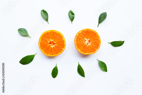 Orange fruits and green leaves on a white background.