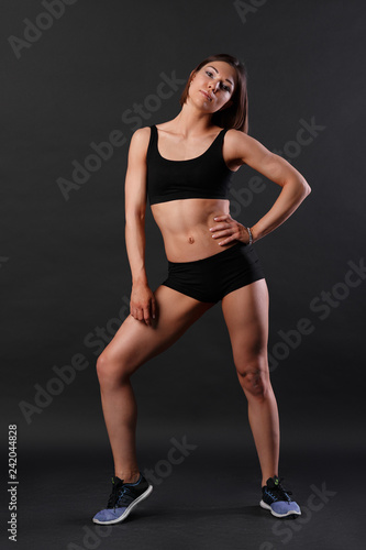 portrait of a tall bodybuilder girl on a dark background