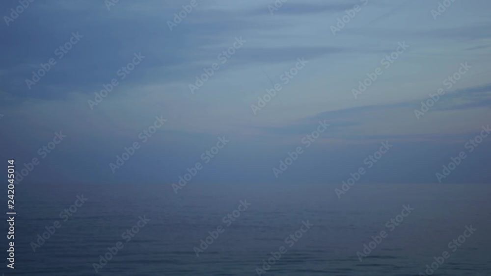 Calm sea and cloudy sky at sunset time in evening. Beautiful nature background. Real time 4k video footage. Calm sea and cloudy sky at sunset time in evening. Beautiful nature background. Real time 4k video footage.