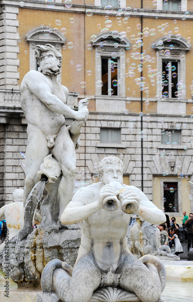 Fontana del Moro in Piazza Navona, Famous square filled with fountains in the heart of Rome, capital of Italy. Soap bubbles on the background.