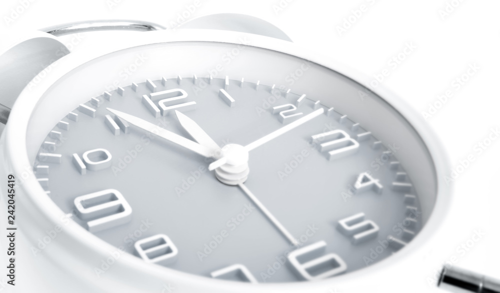 Twin bells analogue alarm clock shows time 5 to 12 with gray clock face, 11.55 AM PM, on white background Twin bells analogue alarm clock shows time 5 to 12 with gray clock face, 11.55 AM PM, on white background