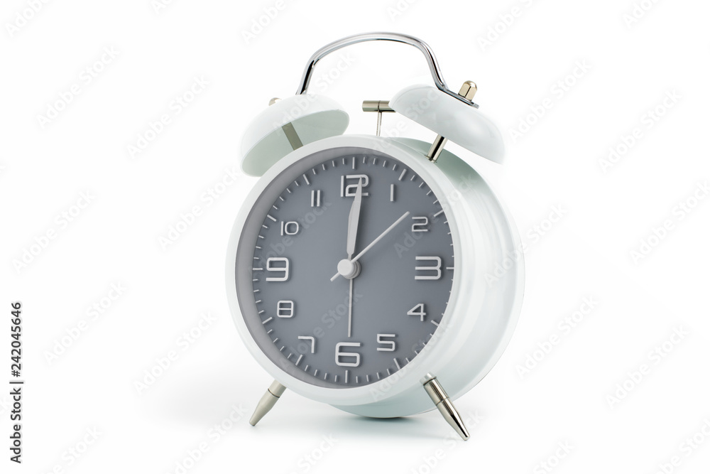 Twin bells analogue alarm clock with gray clock face shows 1 past 12, 12.01 AM PM; concept on white background Twin bells analogue alarm clock with gray clock face shows 1 past 12, 12.01 AM PM; concept on white background