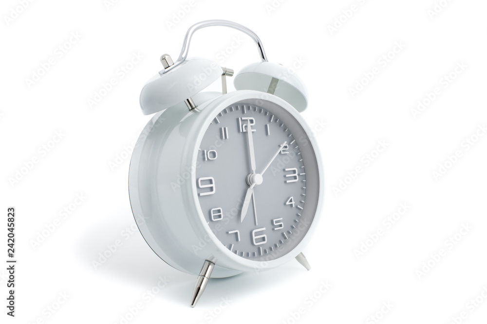 Twin bells analogue alarm clock with gray clock face shows seven o