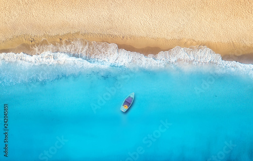 Seashore and boat from top view. Turquoise water background from top view. Summer seascape from air. Top view from drone. Travel concept and idea