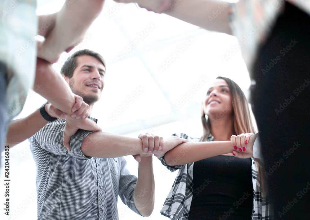 Obraz premium bottom view. creative business team, forms a circle of hands