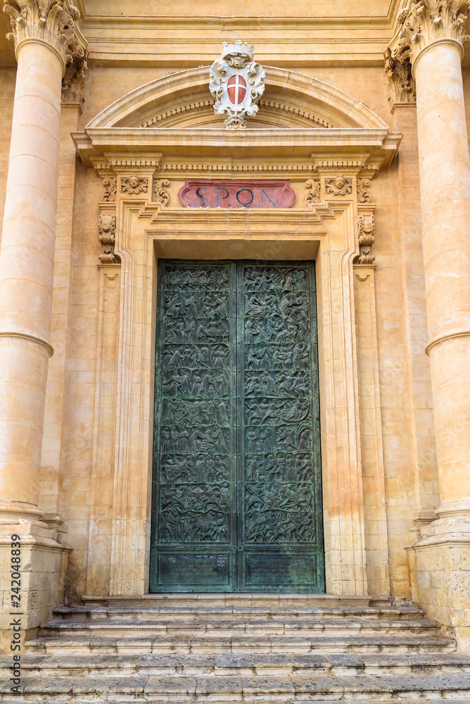 Carved door of Saint Nicholas of Myra Cathedral in Noto
