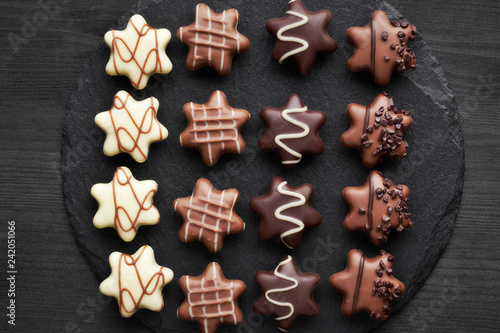 Star-shaped chocolates on dark textured background