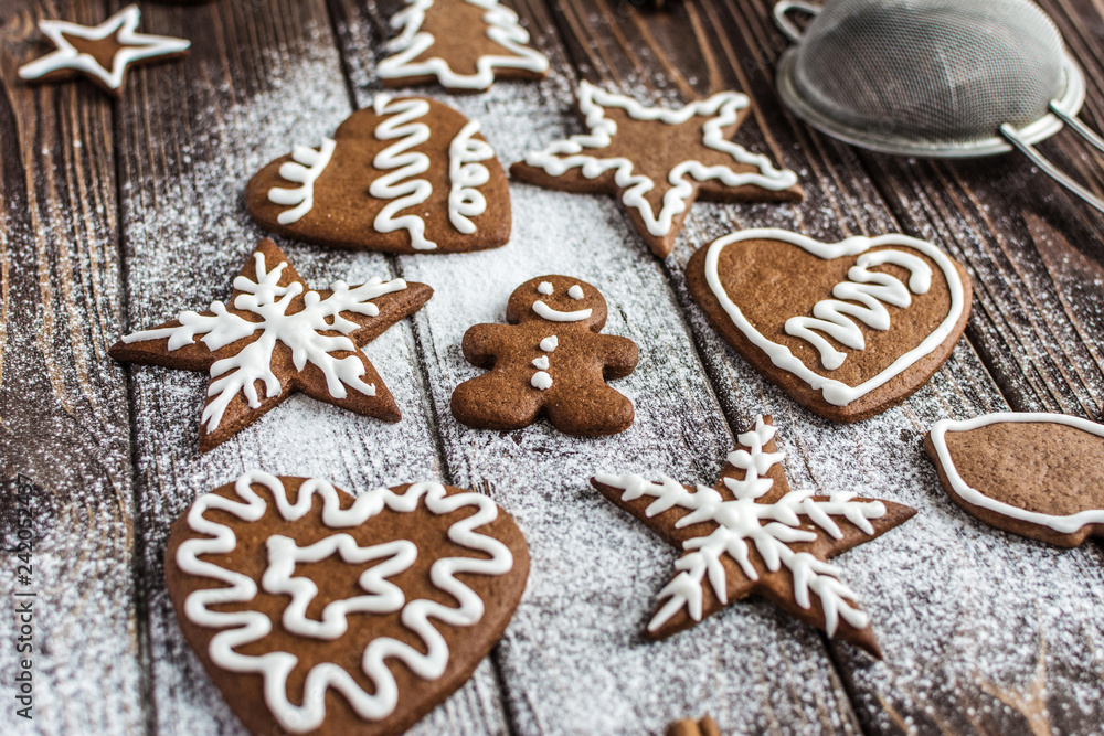 Christmas homemade gingerbread cookies on a wooden background. New year and christmas postcard